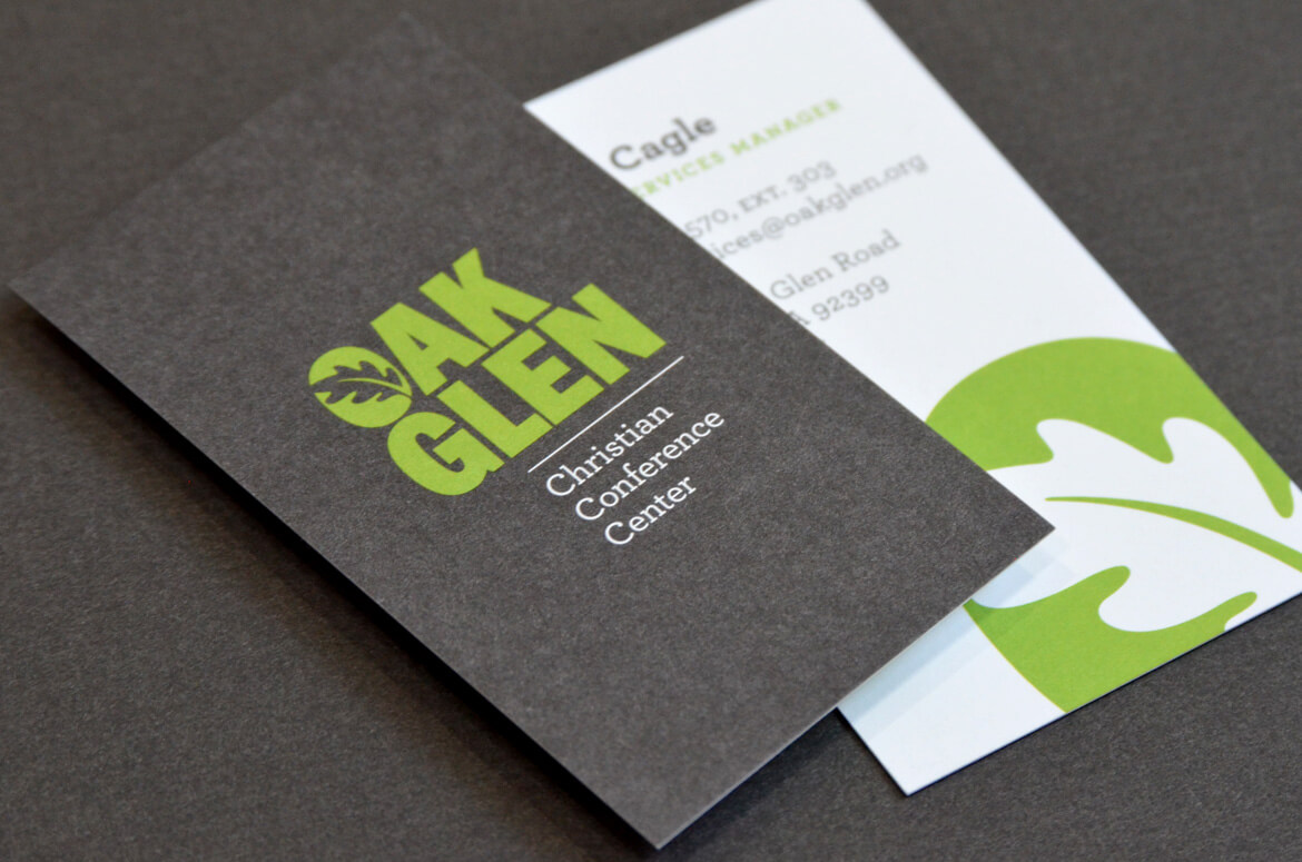 Business cards printed on uncoated paper with green and gray ink.