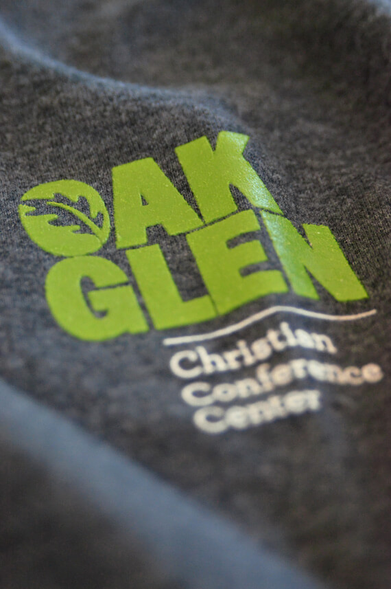 Grey and green T-shirt design for company identity.